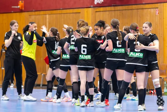 Eine Handballmannschaft die sich nach dem Spiel abklatscht 